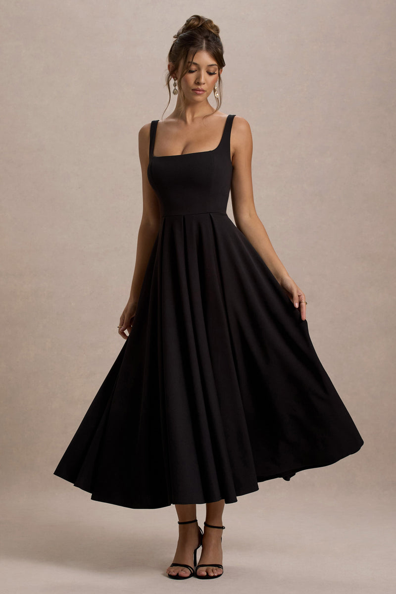 Parina | Vestido midi negro de tirantes con bajo voluminoso