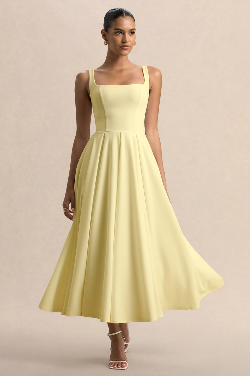 Parina | Vestido midi color limón con tirantes finos y bajo con volumen
