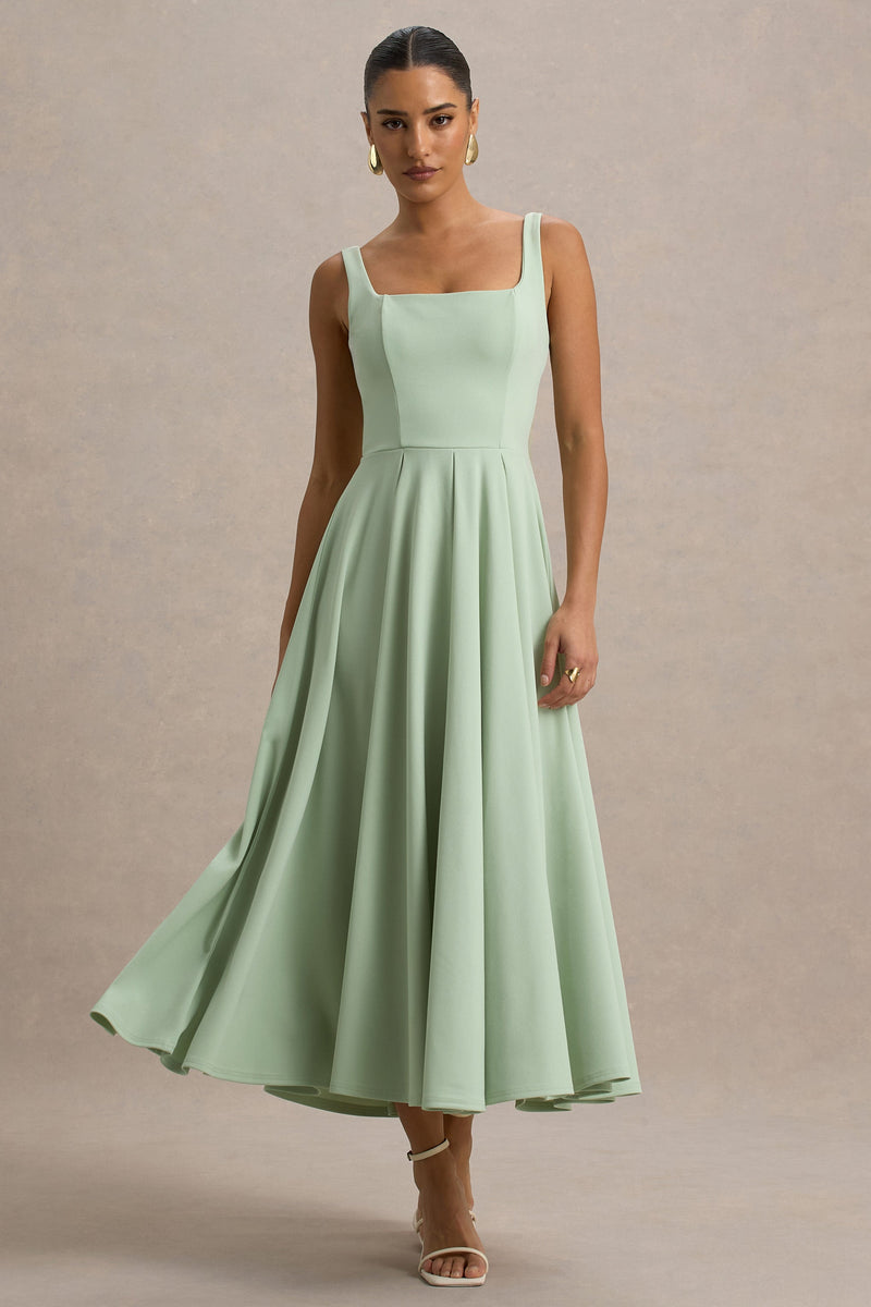 Parina | Vestido midi verde claro de tirantes con bajo voluminoso